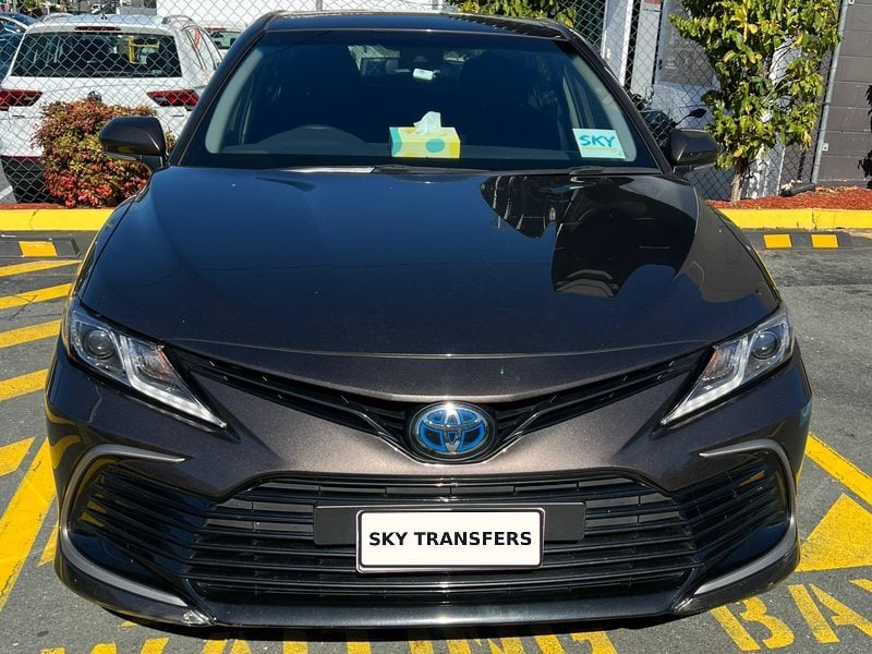 Our Toyota Camry Hybrid, photographed head-on in a waiting bay.